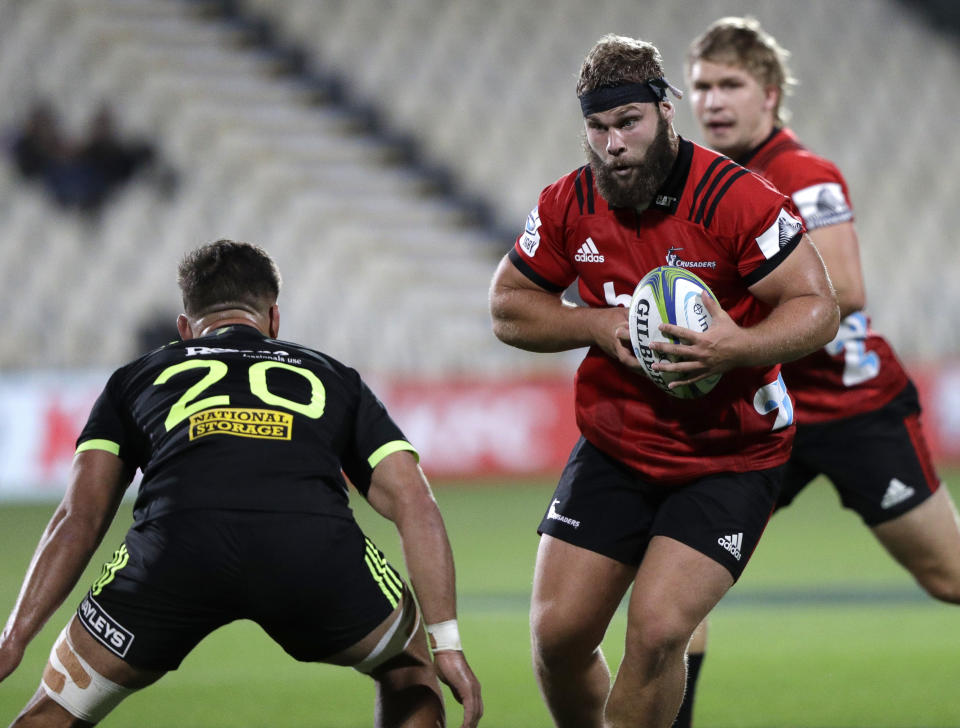 Crusaders Harrison Allan runs at the Hurricanes defence during the Super Rugby game between the Crusaders and Hurricanes in Christchurch, New Zealand, Saturday, Feb. 23, 2019. (AP Photo/Mark Baker)