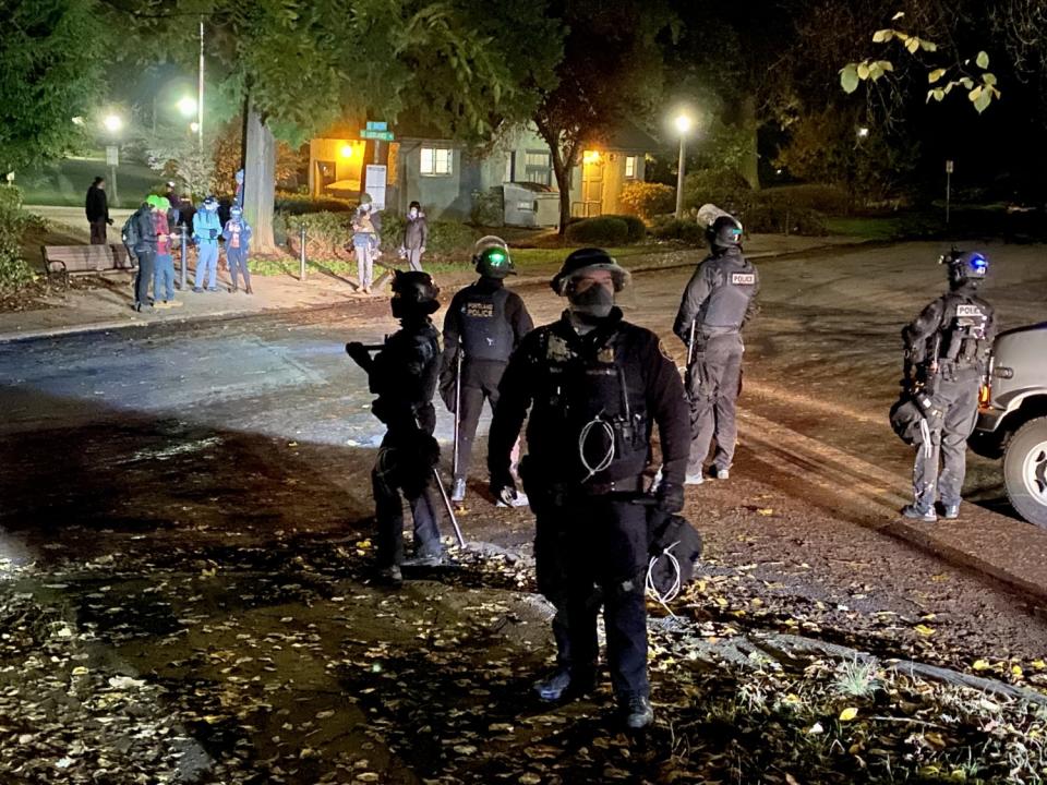 Portland police look for anarchists who slipped away after smashing windows at the county Democratic Party headquarters.