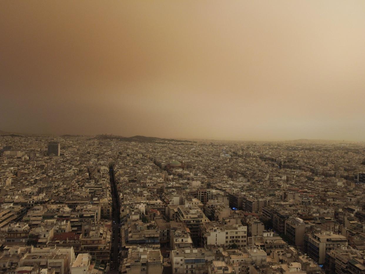 Athens, Greece. 23 April 2024. In a aerial view the Greek capital is seen covered by Sahara dust. Meteorologists have warned of a new wave of Sahara dust and mud rainfalls forecast to hit the country in the next two days. Credit: Dimitris Aspiotis/Alamy Live News