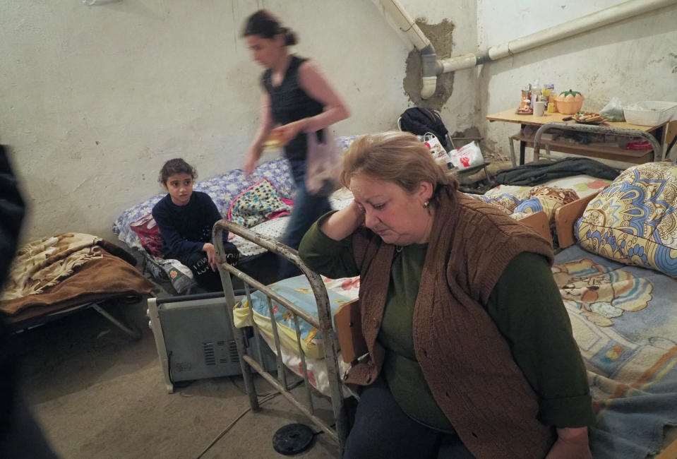 People take refuge in a bomb shelter in Stepanakert, the separatist region of Nagorno-Karabakh, Thursday, Oct. 22, 2020. Heavy fighting over Nagorno-Karabakh continued Thursday with Armenia and Azerbaijan trading blame for new attacks, hostilities that raised the threat of Turkey and Russia being drawn into the conflict. (AP Photo)