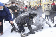 A policeman detains a man while protesters try to help him, during a protest against the jailing of opposition leader Alexei Navalny in St. Petersburg, Russia, Sunday, Jan. 31, 2021. Thousands of people have taken to the streets across Russia to demand the release of jailed opposition leader Alexei Navalny, keeping up the wave of nationwide protests that have rattled the Kremlin. Hundreds have been detained by police. (AP Photo/Valentin Egorshin)
