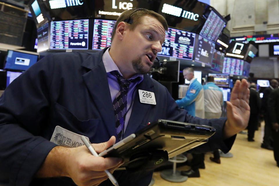 FILE - In a Thursday, Jan. 3, 2019 file photo, trader Michael Milano works on the floor of the New York Stock Exchange. One recent characteristic of the stock market is that every day can feel like bedlam. Investors have been careening from fear to relief and back again depending on the latest news. More tests of the market’s mettle lie ahead, with U.S.-China trade talks, the fourth-quarter earnings period and another Federal Reserve meeting on the horizon. (AP Photo/Richard Drew, File)