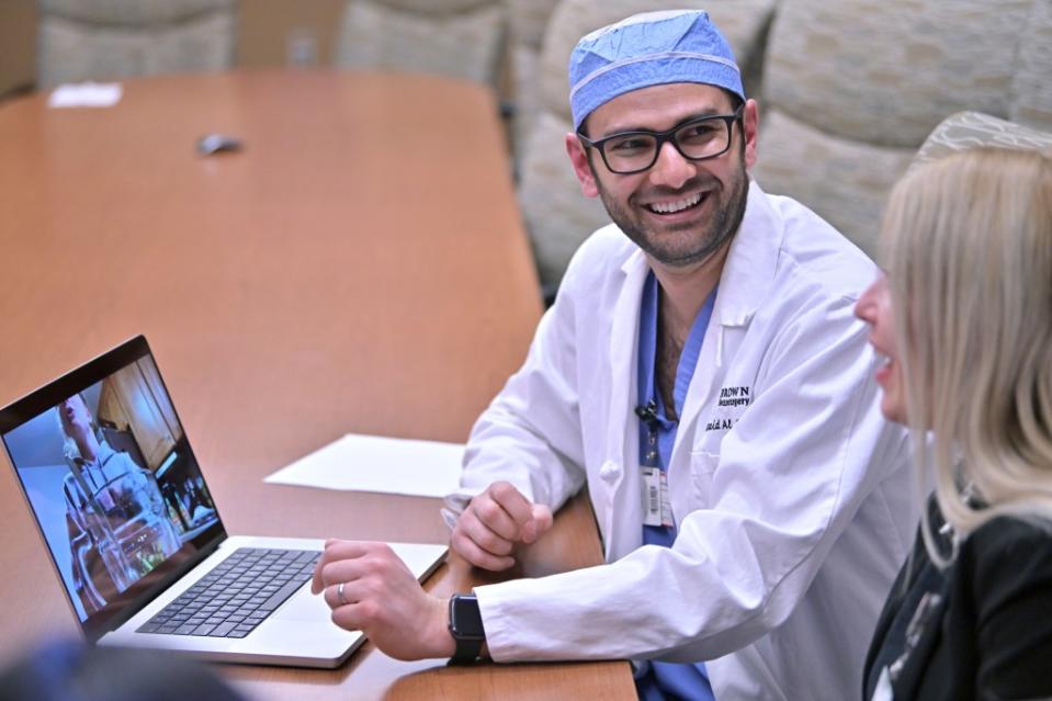 Dr. Rohaid Ali plays a video from a high school project made by his patient Alexis Bogan. AP Photo/Josh Reynolds