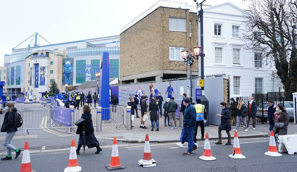 People queue for a booster in a pop-up clinic at Chelsea FC’s Stamford Bridge Stadium (Ian West/PA) (PA Wire)