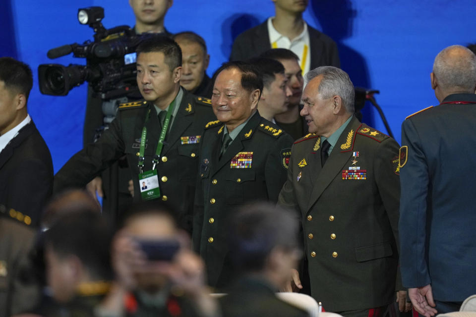 Russian Defense Minister Sergei Shoigu, center right, chats with Zhang Youxia, Chinese general in the People's Liberation Army (PLA), center, as they arrive to the opening ceremony for the Xiangshan Forum, a gathering of the region's security officials, in Beijing, Monday, Oct. 30, 2023. (AP Photo/Ng Han Guan)