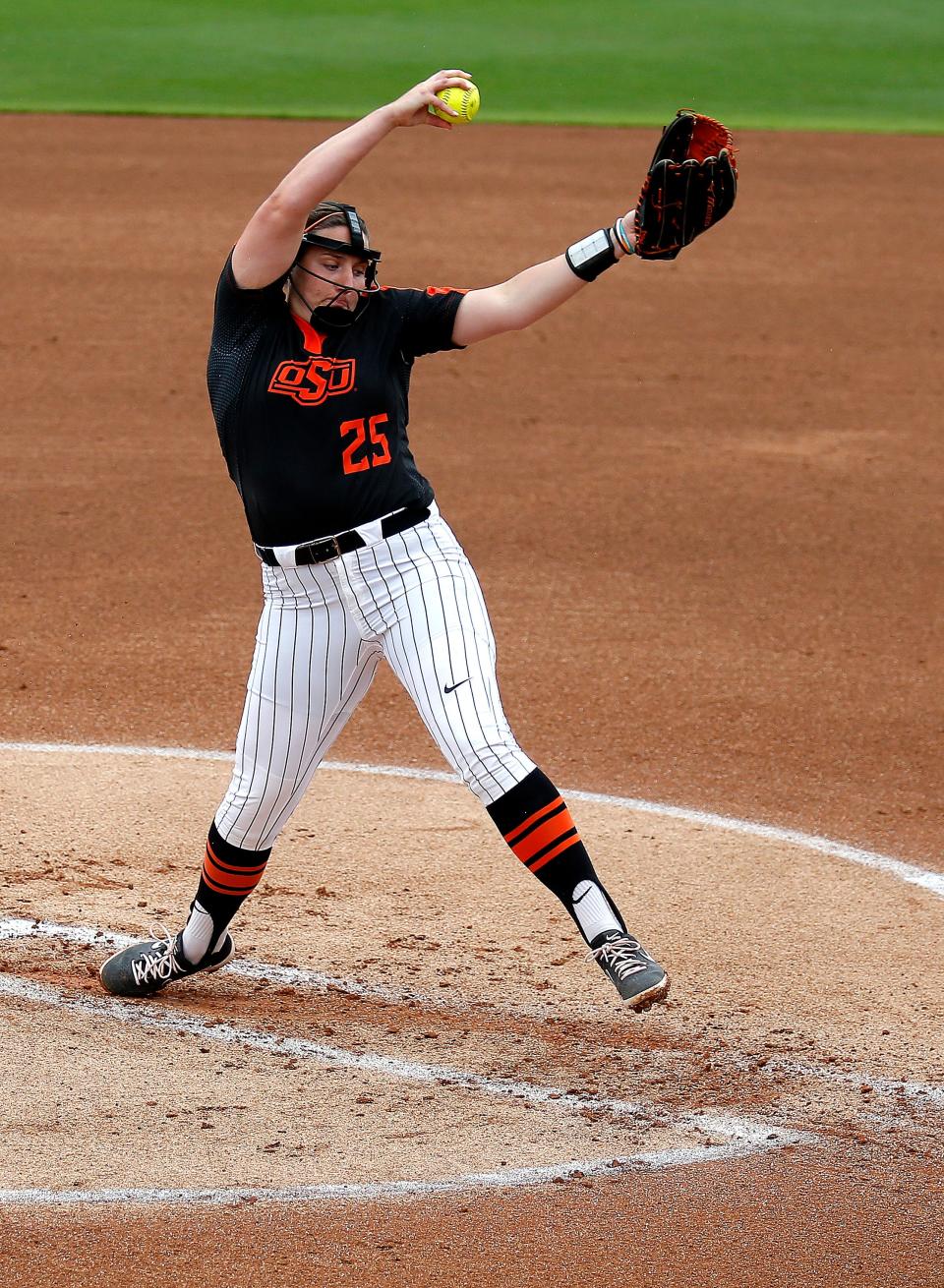 Oklahoma State's Carrie Eberle (25) throws a pitch in the first inning during the NCAA softball regional game between the Oklahoma State Cowgirls and the Mississippi State Bulldogs at Cowgirls Stadium in Stillwater, Okla., Sunday, May 23, 2021. OSU won 10-2.