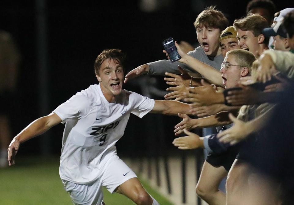 University of Akron's Jason Shokalook celebrates his goal with Zip fans in the second half against Michigan State University in their men's soccer match in Akron on Monday. The Zips beat the Spartans 2-1.