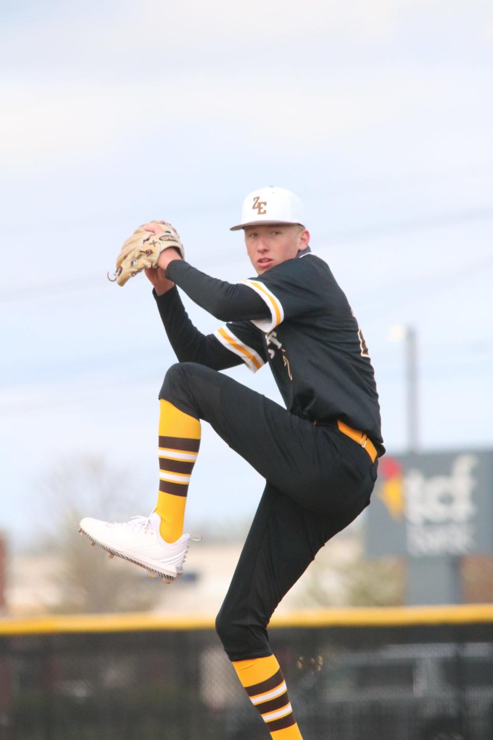 Zeeland East sophomore Trevor Raade winds up to throw a pitch