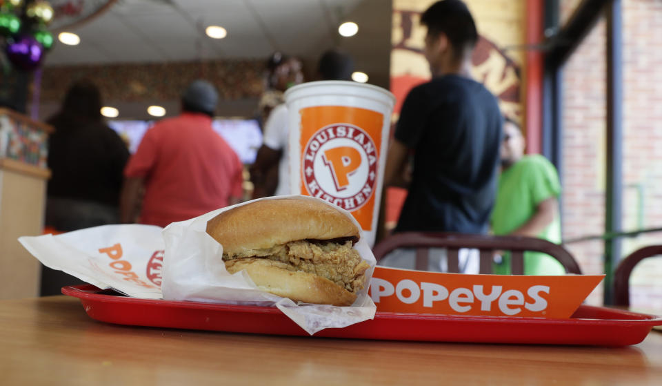 A chicken sandwich sits on a table at a Popeyes as guests wait in line, Thursday, Aug. 22, 2019, in Kyle, Texas. After Popeyes added a crispy chicken sandwich to their fast-fast menu, the hierarchy of chicken sandwiches in America was rattled, and the supremacy of Chick-fil-A and others was threatened. It’s been a trending topic on social media, fans have weighed in with YouTube analyses and memes, and some have reported long lines just to get a taste of the new sandwich. (AP Photo/Eric Gay)
