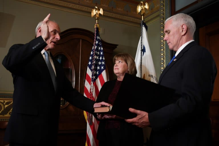John Kelly (L), pictured being sworn in by US Vice President President Mike Pence as Secretary of Homeland Security, has said a border wall might not "be built anytime soon"