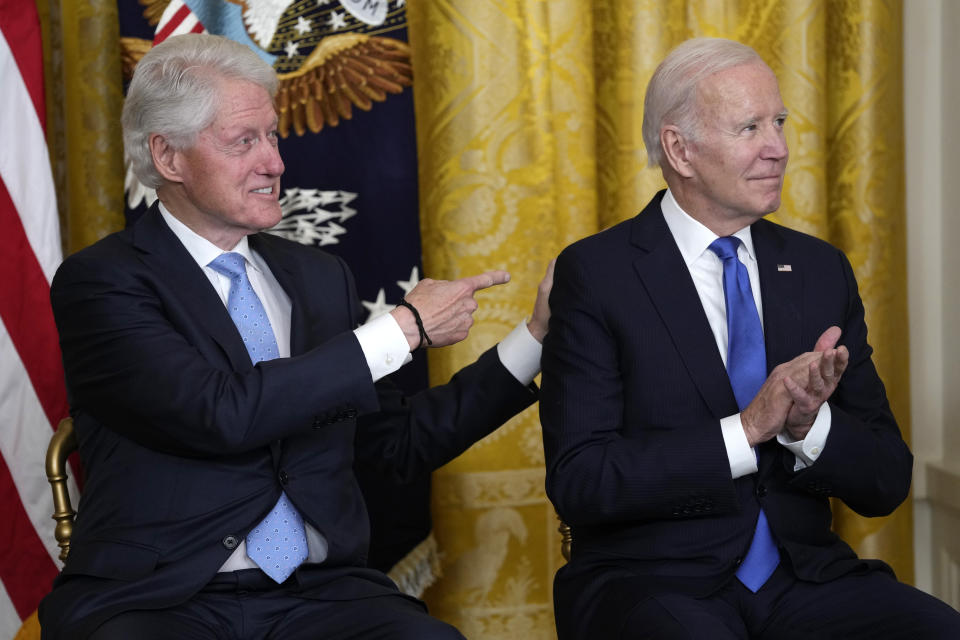 Former President Bill Clinton points to President Joe Biden as they listen to Vice President Kamala Harris speak in the East Room of the White House in Washington, Thursday, Feb. 2, 2023, at an event to mark the 30thAnniversary of the Family and Medical Leave Act. (AP Photo/Susan Walsh)