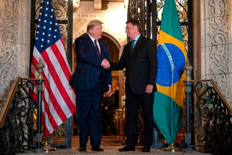 US President Donald Trump (L) shakes hands with Brazilian President Jair Bolsonaro during a diner at Mar-a-Lago in Palm Beach, FloridaAFP via Getty Images