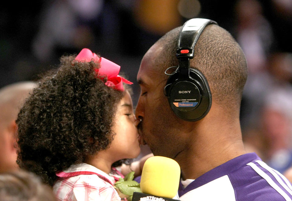Kobe Bryant #24 of the Los Angeles Lakers kisses daughter Gianna following the game with the Memphis Grizzlies on April 12, 2009 at Staples Center in Los Angeles, California. (Photo by Stephen Dunn/Getty Images)