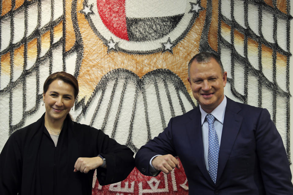 UAE Minister of State for Food and Water Security Mariam al-Muhairi, left, and Erel Margalit, founder and chairman of Jerusalem Venture Partners, touch elbows after their meeting at the headquarter of the Government Accelerators in Dubai, United Arab Emirates, Tuesday, Oct. 27, 2020. Another plane full of Israeli business people excited about their newfound access to the UAE has touched down in Dubai this week. It's the latest whirlwind trip seeking to cash in on a U.S.-brokered deal to normalize relations between the countries. (AP Photo/Kamran Jebreili)