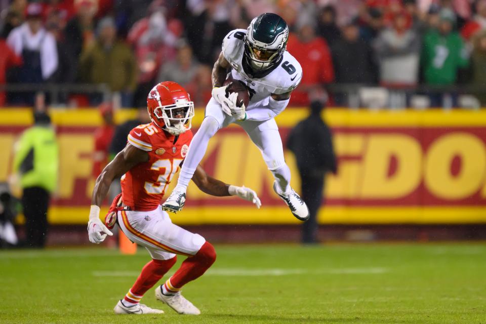 Philadelphia Eagles wide receiver DeVonta Smith (6) makes a catch in front of Kansas City Chiefs cornerback Jaylen Watson (35) during the second half of an NFL football game, Monday, Nov. 20, 2023 in Kansas City, Mo.