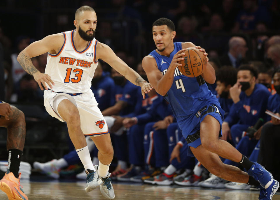 Orlando Magic's Jalen Suggs (4) dribbles past New York Knicks' Evan Fournier (13) during an NBA basketball game Sunday, Oct. 24, 2021, in New York. (AP Photo/John Munson)
