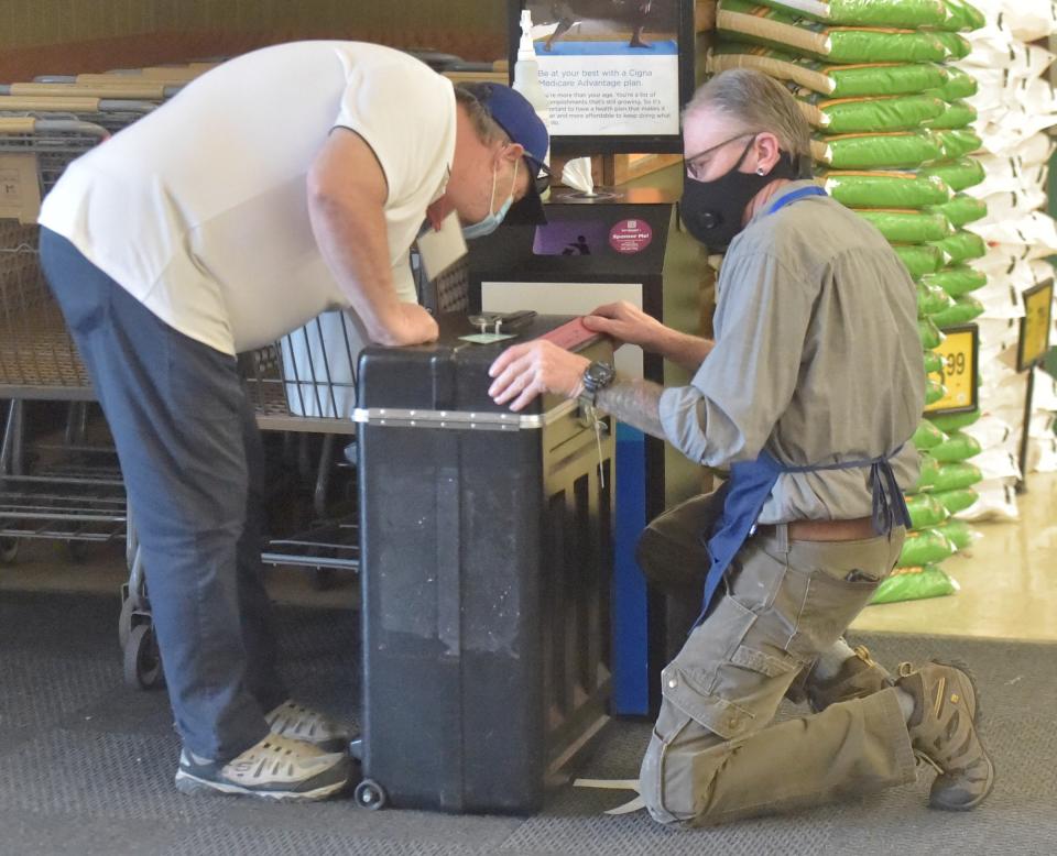 Election judge David Leathers seals a ballot box as another election worker, Eric Smith, prepares to take it away to the Larimer County office building during an exchange of boxes Nov. 3, 2020, at Safeway, 1426 E. Harmony Road, in Fort Collins.