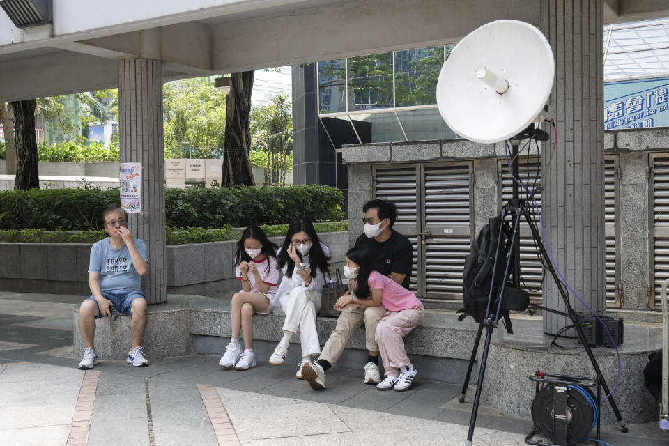 Member of the public wait outside the district court ahead of the verdict on Chung Pui-kuen, the ex-chief editor of the now shuttered Stand News online outlet and his colleague Patrick Lam, former acting chief editor, in Hong Kong on Thursday, Aug. 29, 2024. (AP Photo/Billy H.C. Kwok)