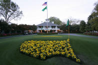 FILE - This April 5, 2006 file photo shows bright yellow flowers in the shape of the United States adorn the lawn at the clubhouse during practice for the 2006 Masters golf tournament at the Augusta National Golf Club in Augusta, Ga. The coronavirus pandemic has killed thousands, forced most everyone to hunker down in their homes, and shut down sporting events around the world. The Masters was not immune to its wrath. (AP Photo/David J. Phillip, File)