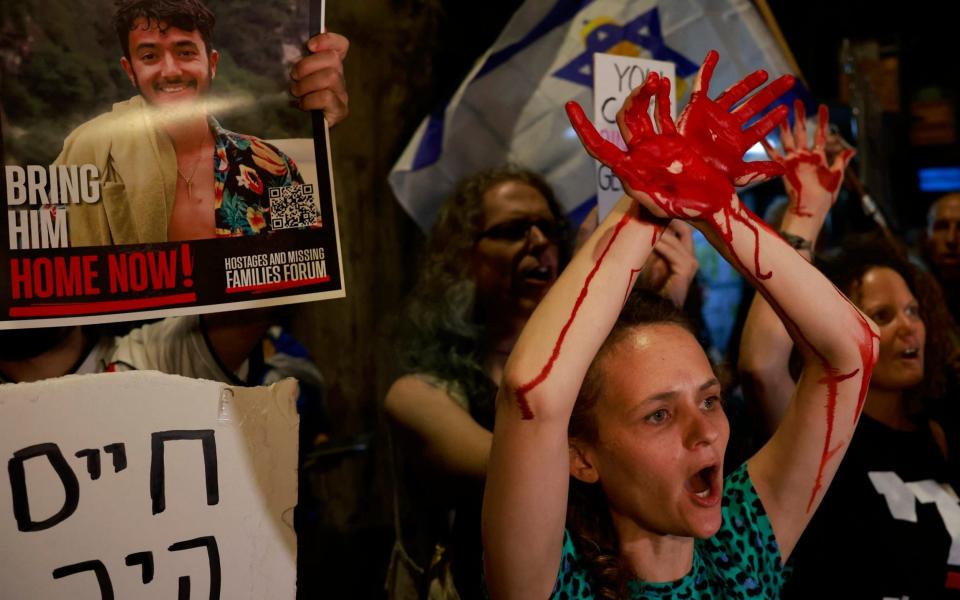 Protestors painted their hands red to symbolise the blood of dead soldiers