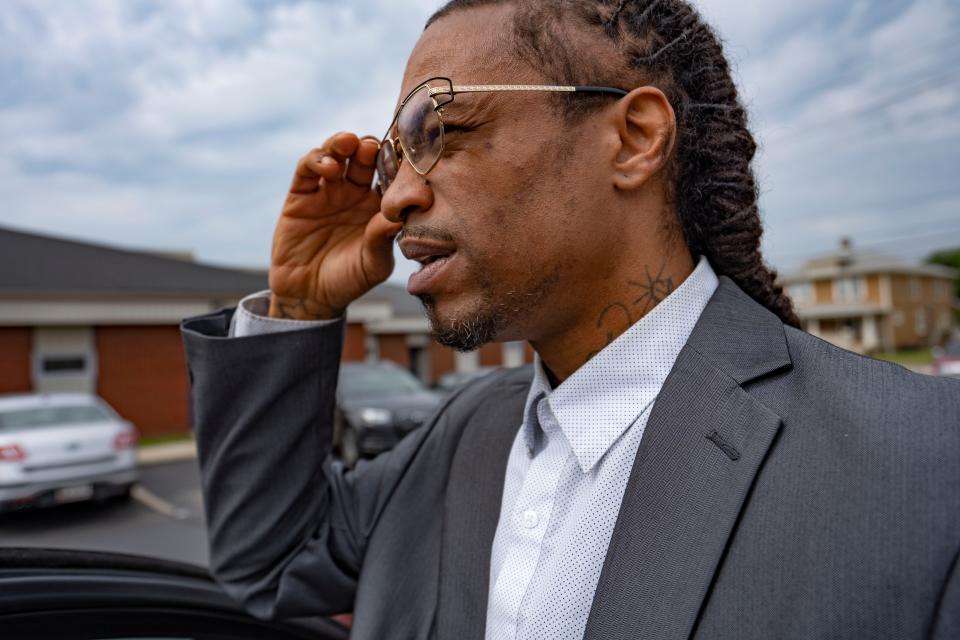 Daniel Mallory, 43, fixes his glasses Wednesday, June 8, 2022, at VOICES in Indianapolis. Mallory is being celebrated as someone who's a father figure for multiple young people in the community.