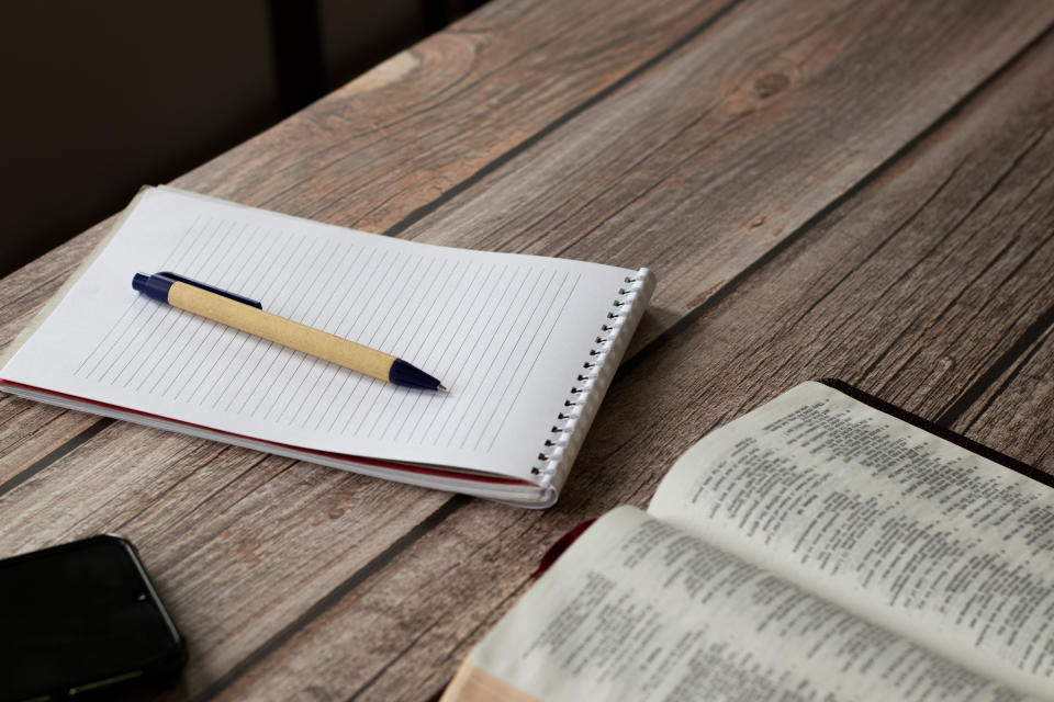 A notebook and a pen on a table