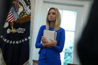 White House press secretary Kayleigh McEnany listens during a meeting between President Donald Trump and Gov. Ron DeSantis, R-Fla., about the coronavirus response, in the Oval Office of the White House, Tuesday, April 28, 2020, in Washington. (AP Photo/Evan Vucci)