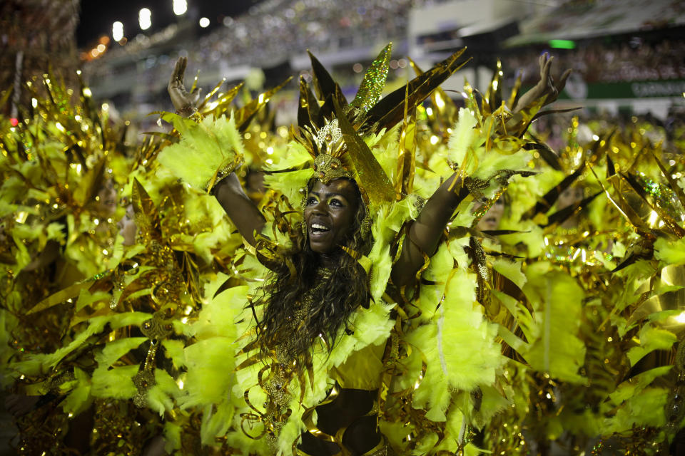 Revelers dance during Beija Flor samba school parade at the Sambadrome in Rio de Janeiro, Brazil, Monday, Feb. 20, 2012. Millions watched the sequin-clad samba dancers at Rio de Janeiro's iconic Carnival parade.  (AP Photo/Victor R. Caivano)