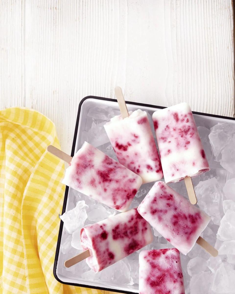 raspberry buttermilk ice pops on a tray filled with ice