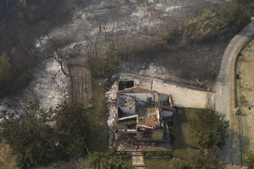 A burnt out house and trees during wildfires near the village of Kirkis, near Alexandroupolis town, in the northeastern Evros region, Greece, Wednesday, Aug. 23, 2023. Water-dropping planes from several European countries joined hundreds of firefighters Wednesday battling wildfires raging for days across Greece that have left 20 people dead, while major blazes were also burning in Spain's Tenerife and in northwestern Turkey near the Greek border. (AP Photo/Achilleas Chiras)