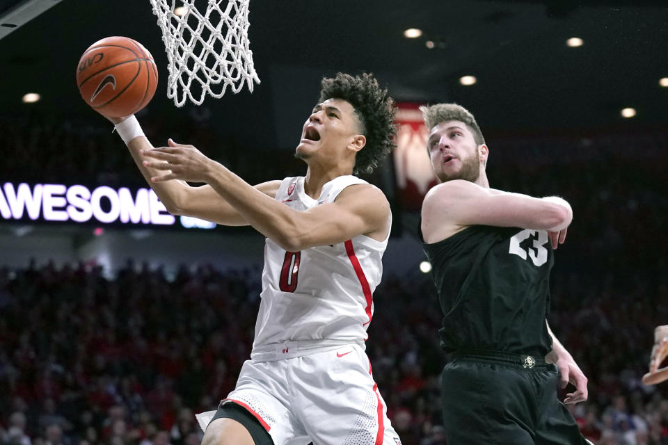 Arizona guard Josh Green (0) drives past Colorado forward Lucas Siewert during the second half of an NCAA college basketball game Saturday, Jan. 18, 2020, in Tucson, Ariz. Arizona won 75-54. (AP Photo/Rick Scuteri)