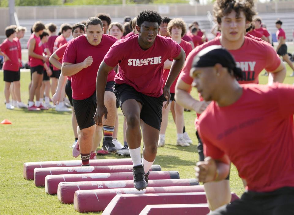 Brophy defensive end Devan Kennedy performs a drill during spring practice at Brophy Prep sports complex in Phoenix on April 24, 2023.