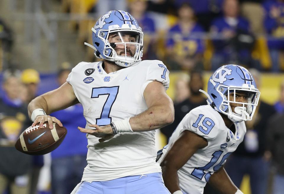 North Carolina quarterback Sam Howell throws against Pittsburgh as Tar Heels running back Ty Chandler, right, looks to make a block.