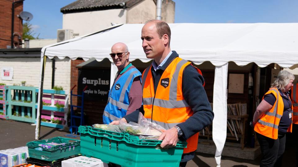 William  helps to load trays of food into vans