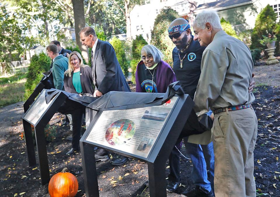 Weymouth officials and members of the Massachusett Tribe at Ponkapoag unveil historical panels at the Wessagussett Wetland and Woodland site off Sea Street on Thursday, Oct. 7, 2021.