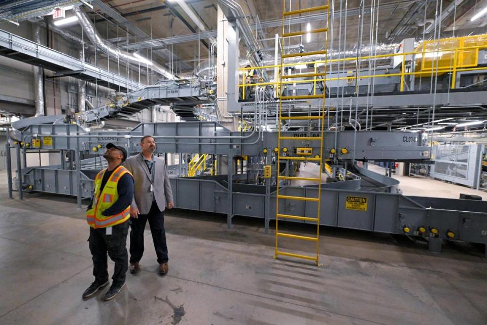 Ryan Shields, a lead technician, left, and Raymond McMahon, site manager Kansas City, both with Vanderlande Industries, Inc., toured the baggage handling screening area the new KCI single terminal.