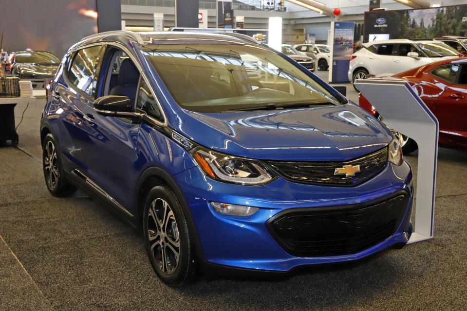 FILE - In this Feb. 13, 2020 file photo a 2020 Chevrolet Bolt EV is displayed at the 2020 Pittsburgh International Auto Show in Pittsburgh. On Thursday, Nov. 19, 2020, General Motors says a pending breakthrough in battery chemistry will cut the price of its electric vehicles so they equal those powered by gasoline within five years. (AP Photo/Gene J. Puskar, File)