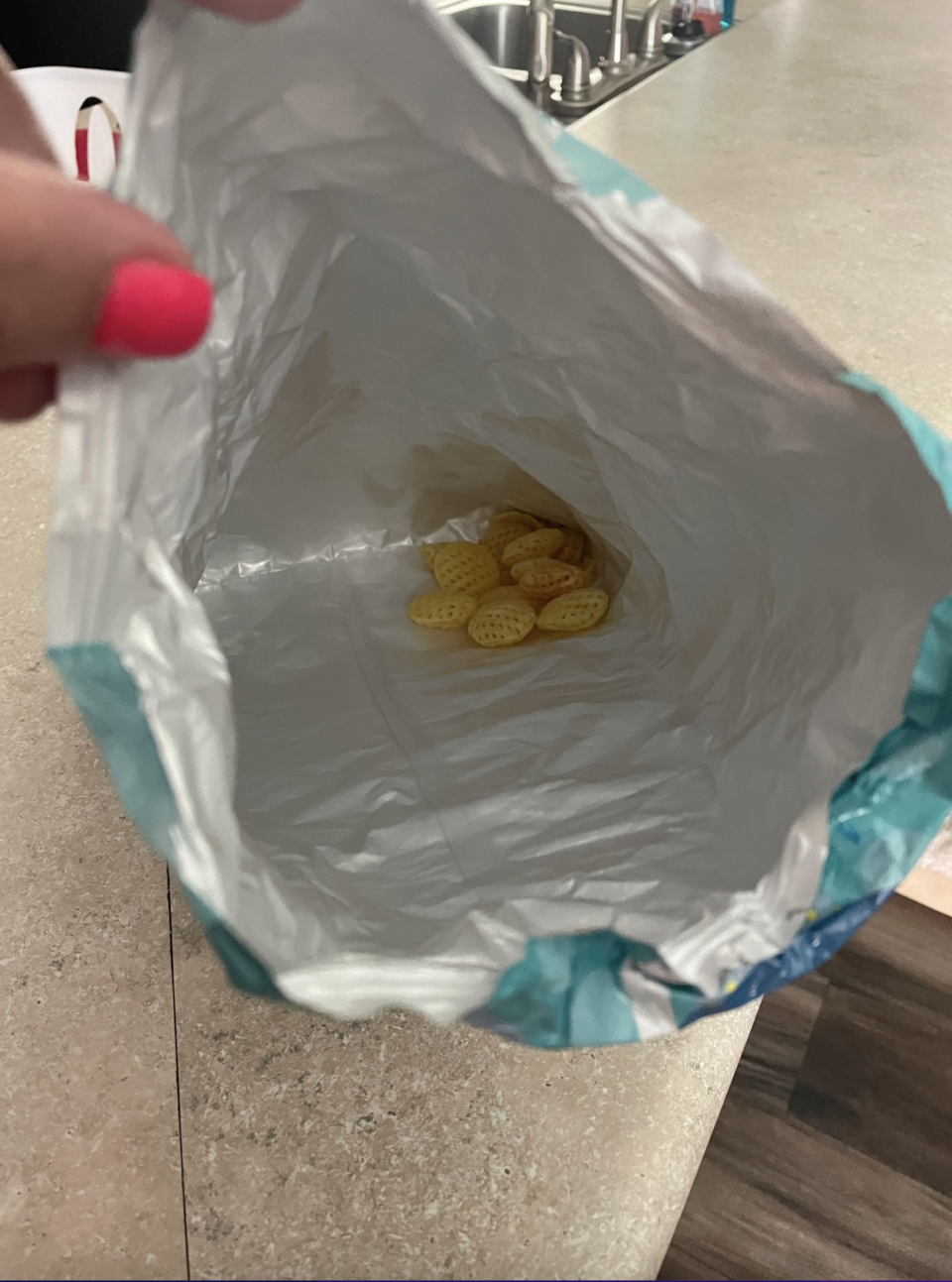 A large, empty snack bag except for a few crumbs at the bottom, with the caption, "My boyfriend's solution to me being mad that he finishes everything in the house without buying a replacement"