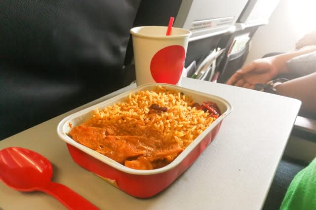 Simple in-flight meal of rice, meat, coffee in disposable utensils