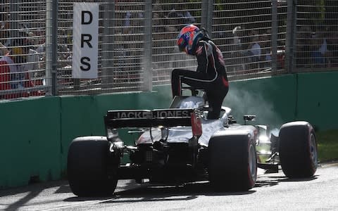 Haas F1's French driver Romain Grosjean leaves his car after crashing during the Formula One Australian Grand Prix in Melbourne on March 25, 2018 - Credit: AFP