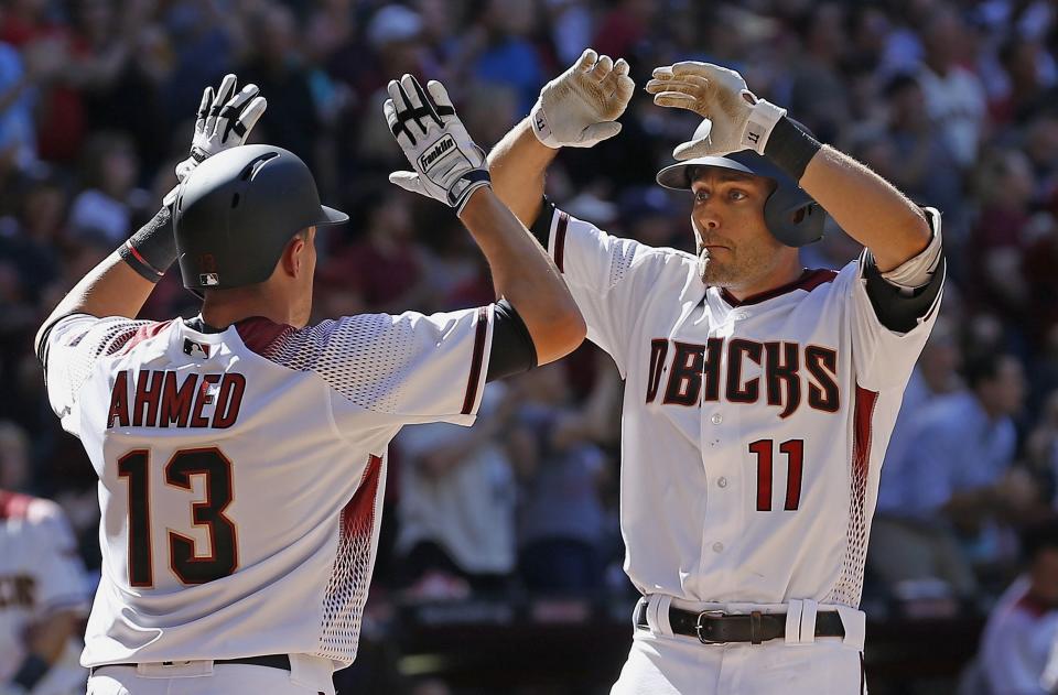 Arizona Diamondbacks' A.J. Pollock (11) celebrates his two-run home run against the San Francisco Giants with Nick Ahmed (13) during the sixth inning of an Opening Day baseball game Sunday, April 2, 2017, in Phoenix. (AP Photo/Ross D. Franklin)