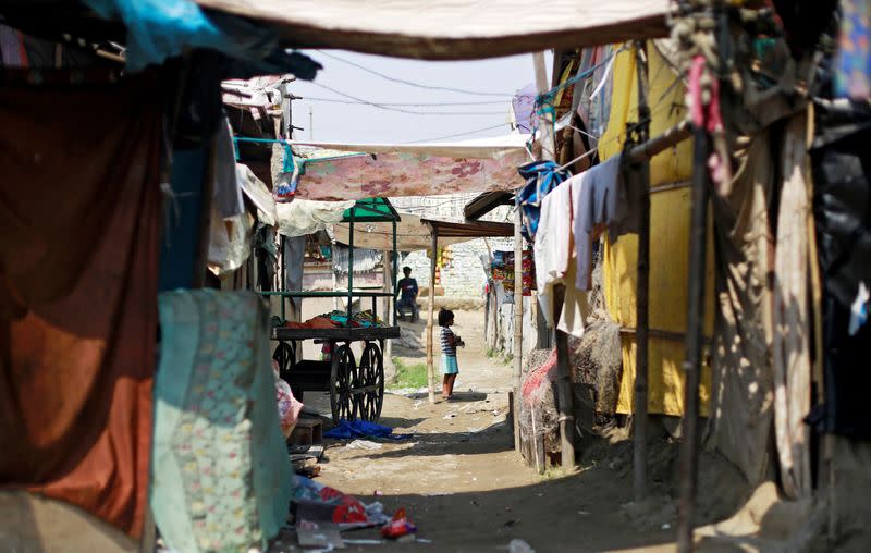 FILE PHOTO: A girl from the Rohingya community stands outside a shop in a camp in New Delhi