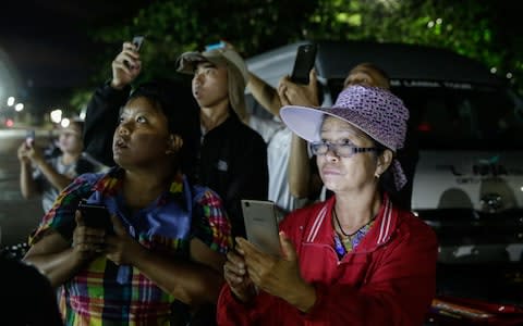 Onlookers watch and cheer as ambulances deliver boys rescued from a cave in northern Thailand to hospital in Chiang Rai  - Credit:  Lauren DeCicca/Getty Images