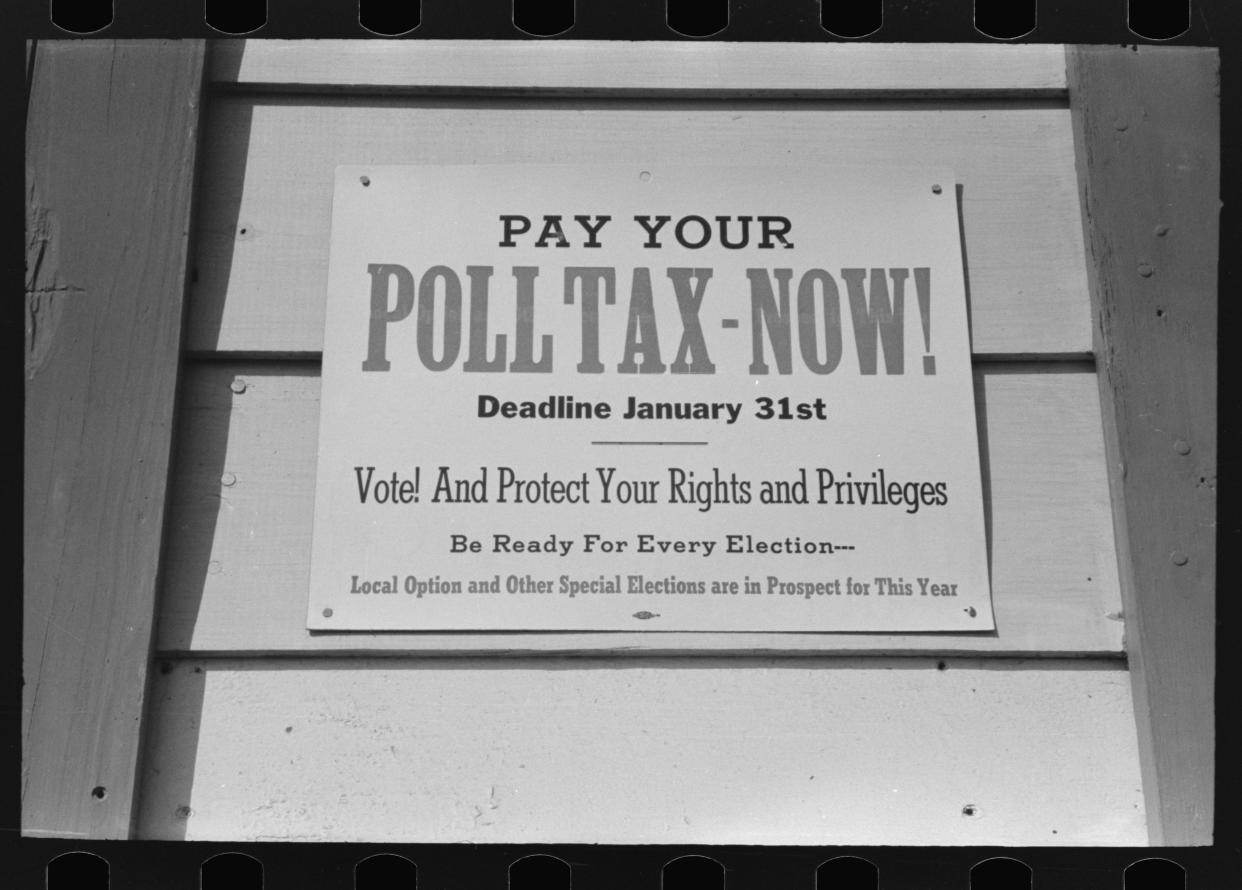 Placard reading: Pay Your Poll Tax Now.