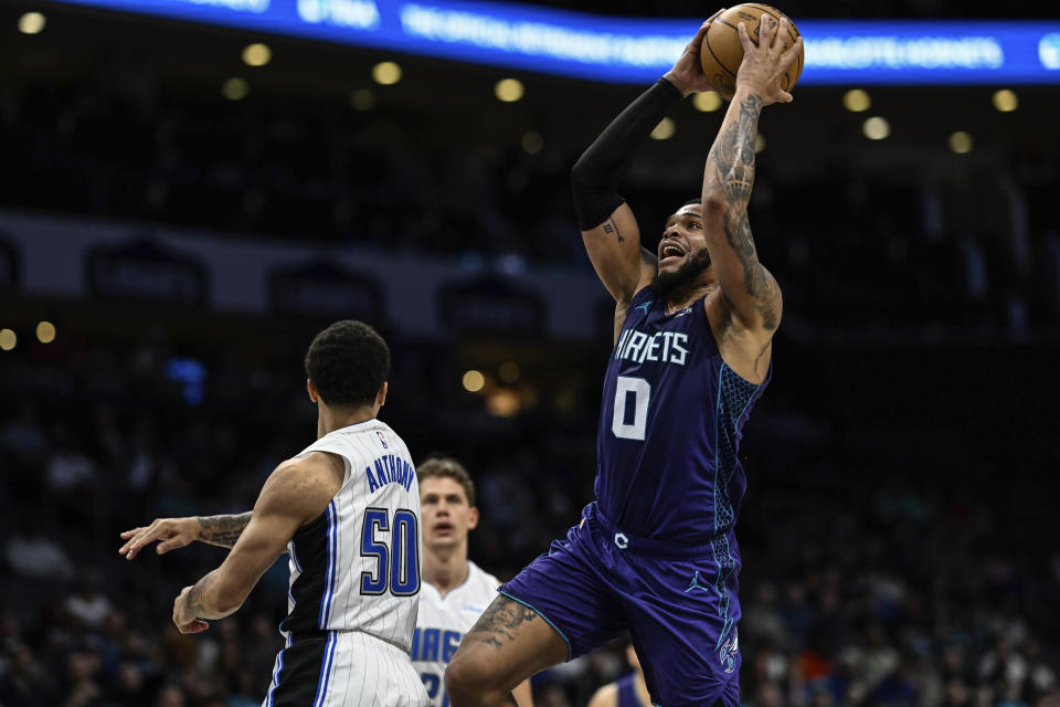 Charlotte Hornets forward Miles Bridges (0) drives to the basket against Orlando Magic guard Cole Anthony (50) during the first half of an NBA basketball game, Tuesday, March 5, 2024, in Charlotte, N.C. (AP Photo/Matt Kelley)