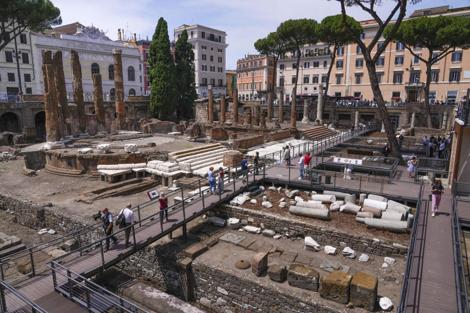 Journalists visit the new walkways of the so called 'Sacred Area' where four temples, dating back as far as the 3rd century B.C., stand smack in the middle of one of modern Rome's busiest crossroads, Monday, June 19, 2023, With the help of funding from Bulgari, the luxury jeweler, the grouping of temples can now be visited by the public that for decades had to gaze down from the bustling sidewalks rimming Largo Argentina (Argentina Square) to admire the temples below where Julius Caesar masterminded his political strategies and was later fatally stabbed in 44 B.C. (AP Photo/Domenico Stinellis)