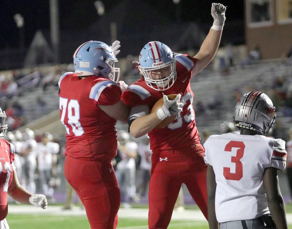 Alliance's Kevin Frazier, left, and Adam Zumbar celebrate after Zumbar's first-half touchdown against Minerva, Friday, Oct. 13, 2023.