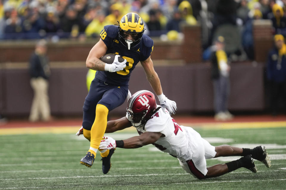 Michigan tight end Colston Loveland (18) runs through the tackle of Indiana linebacker Aaron Casey (44) in the first half of an NCAA college football game in Ann Arbor, Mich., Saturday, Oct. 14, 2023. (AP Photo/Paul Sancya)