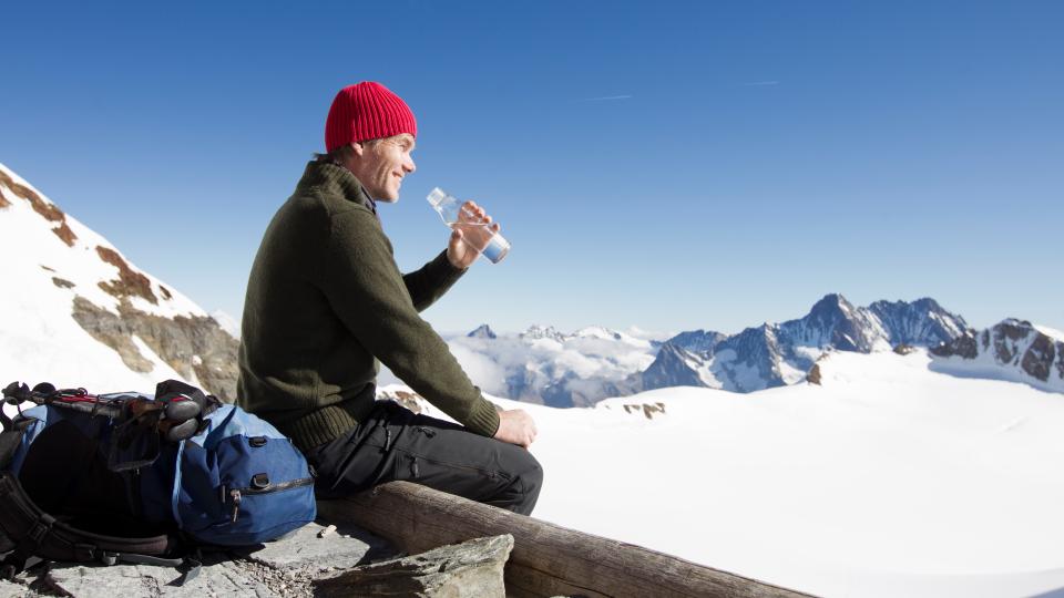 hiker drinking water on viewing platform