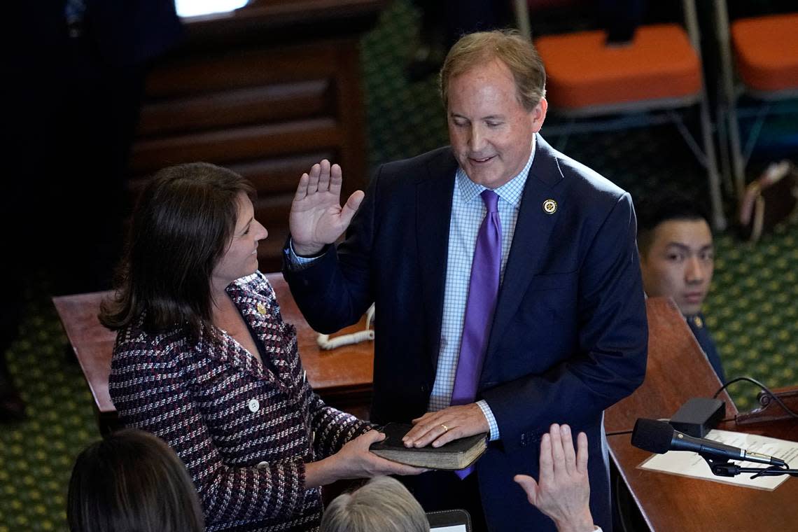 FILE - Texas Attorney General Ken Paxton, right, stands with his wife Texas state Sen. Angela Paxton, left, as he is sworn in for a third term in Austin, Texas, Tuesday, Jan. 10, 2023. Ken Paxton has agreed to apologize and pay $3.3 million in taxpayer money to four former staffers who accused him of corruption in 2020, igniting an ongoing FBI investigation of the three-term Republican. Under terms of a preliminary lawsuit settlement filed Friday, Feb. 10, 2023, Paxton made no admission of wrongdoing to accusations of bribery and abuse of office, which he has denied for years and called politically motivated. (AP Photo/Eric Gay, File)